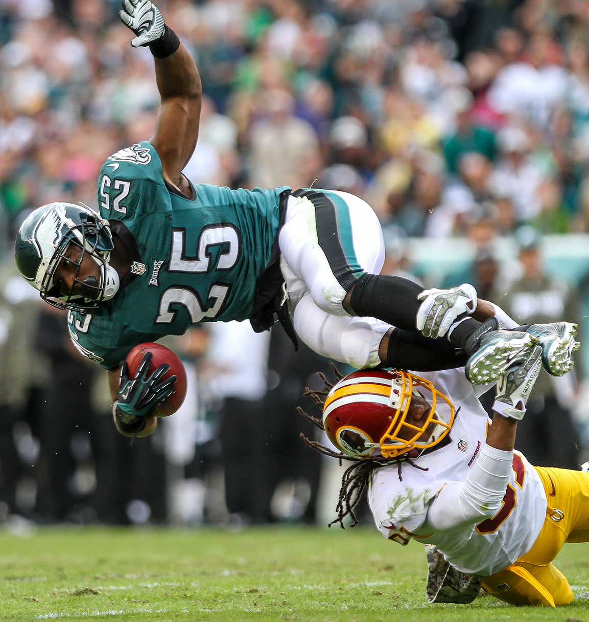 Eagles running back LeSean McCoy is upended by Redskins safety Brandon Meriweather. Photographed by Delaware Senior Portrait Photographer Andre El Photography